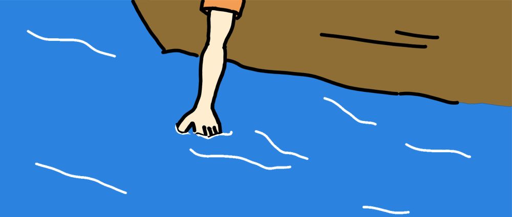 hand in water from a boat
